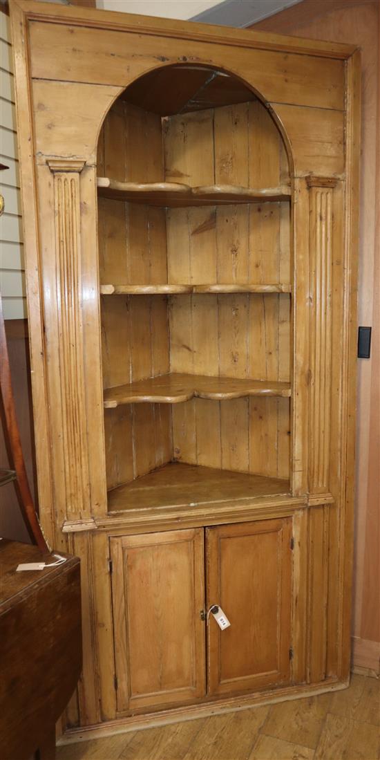 A late 18th century stripped pine standing corner cabinet W.230cm